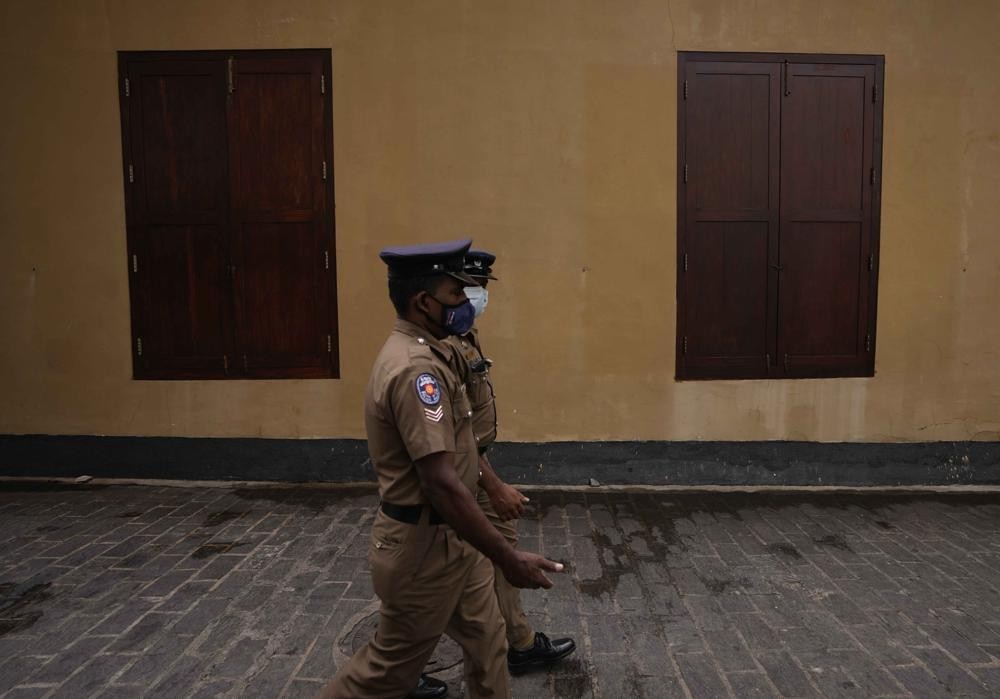 Sri Lankan police officers walk past a closed restaurant during a country wide strike in Colombo, Sri Lanka, Friday, May 6, 2022. Protesters have hung undergarments near Sri Lanka’s Parliament while shops, offices and schools closed and transport came to a near standstill amid nationwide demonstrations against the government over its alleged inability to resolve the worst economic crisis in decades. (AP Photo/Eranga Jayawardena)
